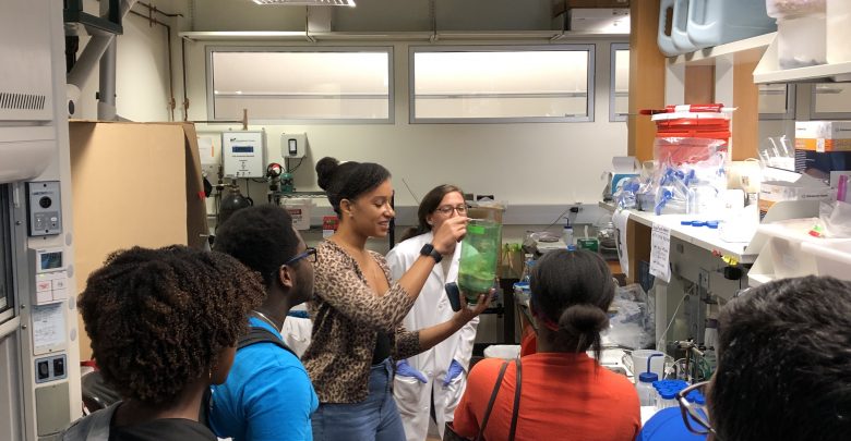 Erica Dasi from the College of Engineering shows a lab-made bio-sand filter from Dr. Ergas’ environmental engineering lab.