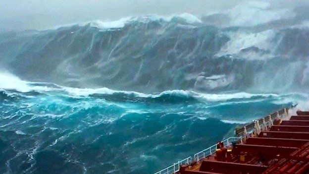 Figure 1. A large rogue wave approaching a cargo ship.