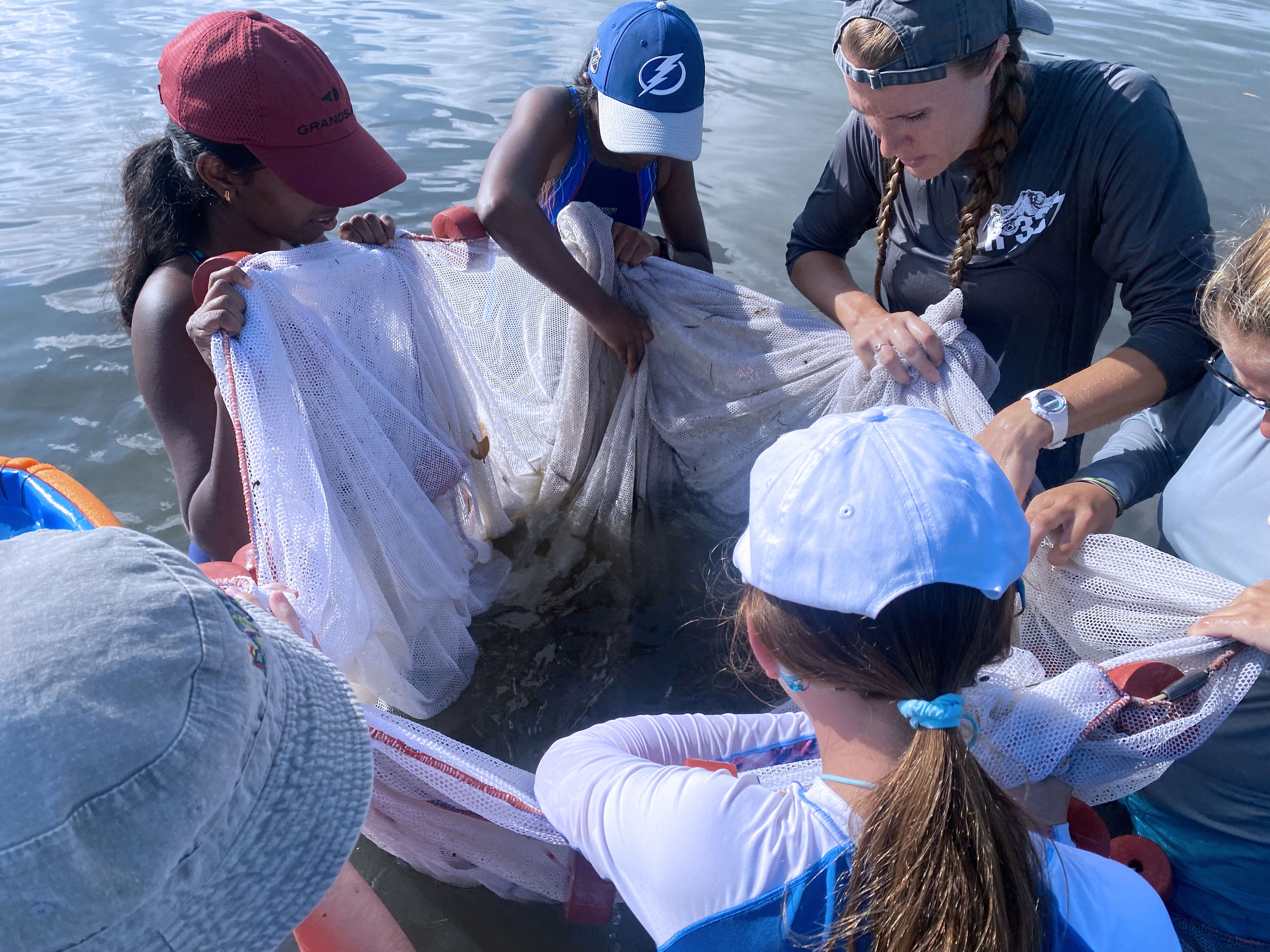 Oceanography camp for girls campers and staff measuring fish at Fort De Soto.