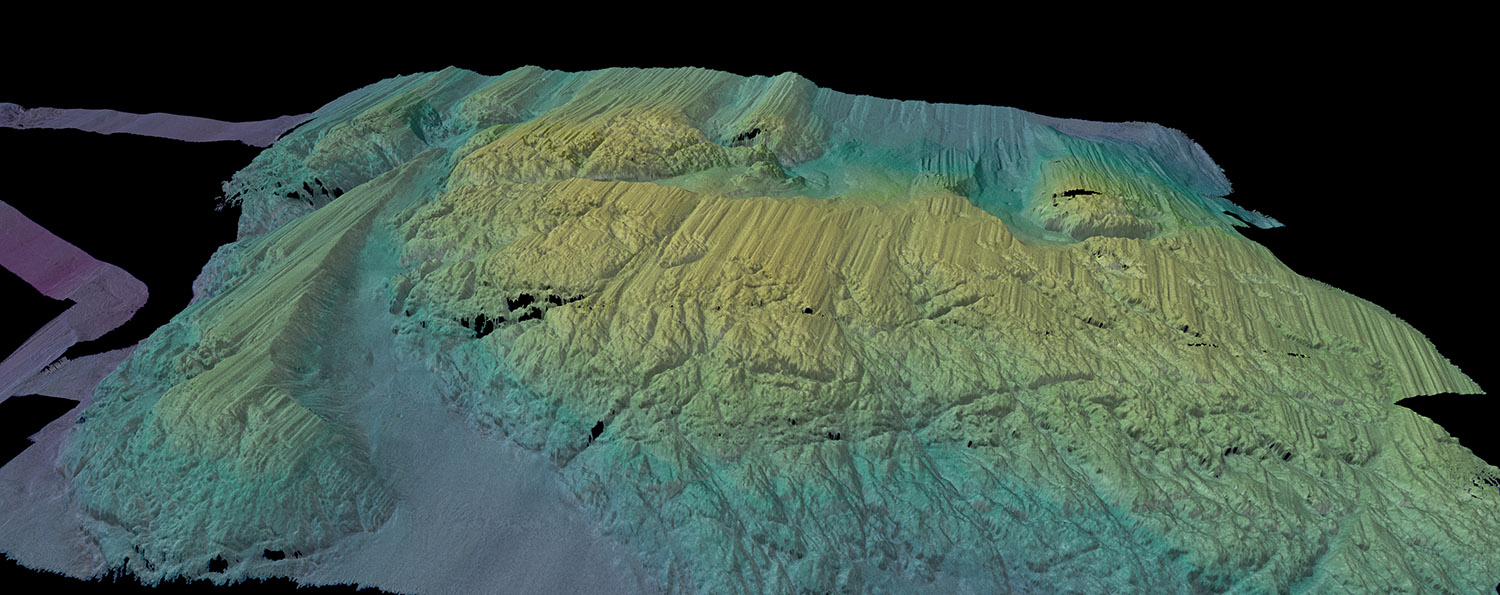 A 3D-rendered view of the multibeam bathymetry (seafloor shape) colored by depth, collected by Rán across a seabed ridge, just in front of Thwaites Ice Shelf. (Credit: Alastair Graham/University of South Florida).