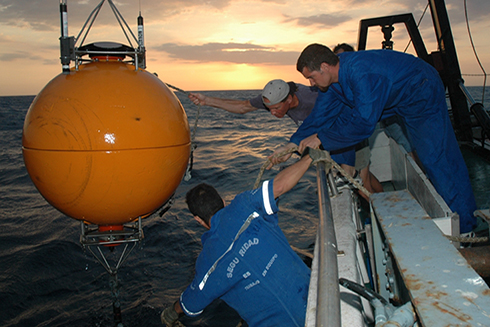 A CARIACO team recovers the buoy that housed the Acoustic Doppler Current Profiler (ADCP). Data from the ADCP revealed a daily migration of fish into and out of the anoxic waters in the morning and evening.