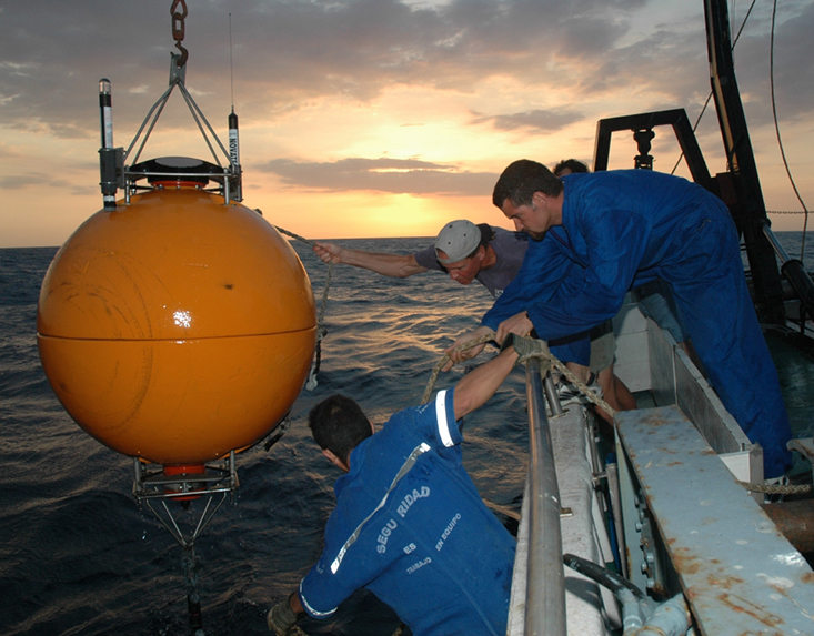 A CARIACO team recovers the buoy that housed the Acoustic Doppler Current Profiler (ADCP). Data from the ADCP revealed a daily migration of fish into and out of the anoxic waters in the morning and evening.