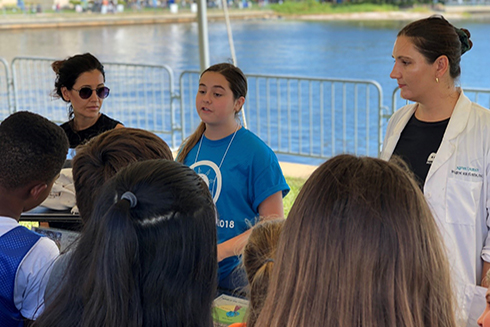 A Junior Scientist explains the diet of Florida black bears at the Imagine Our Florida, Inc. booth during the 2018 St. Petersburg Science Festival. 