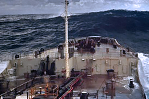 A ship approaches a rogue wave, estimated to be 18.3 meters (60 feet) off Charleston, South Carolina. Rogue waves are unpredictable, dangerous, and huge - at least twice the height of surrounding waves. Photo courtesy of NOAA.