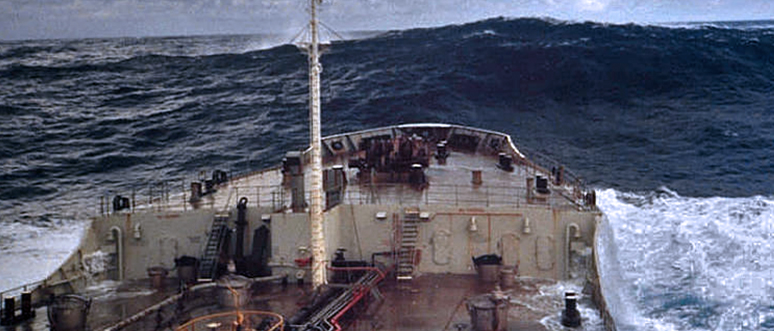 A ship approaches a rogue wave, estimated to be 18.3 meters (60 feet) off Charleston, South Carolina. Rogue waves are unpredictable, dangerous, and huge - at least twice the height of surrounding waves. Photo courtesy of NOAA. 