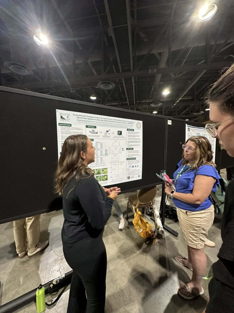 A student presents their research during a poster session in the first coastal and marine ecology session at ESA. 