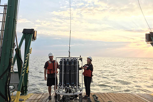 Lead author Dr. Anni Djurhuus (right) from the University of the Faroe Islands (formerly USF College of Marine Science) and coauthor Dr. Enrique Montes (USF College of Marine Science) manage the Rosette water sampler. All scientists need to perform a marine eDNA study of this sort is about a liter of water.