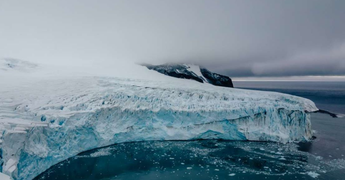 A beautiful Antarctic glacier (Representative Cover Image Source: Unsplash| Tetiana Grypachevska )