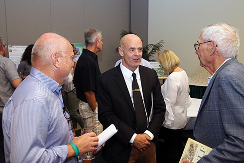 Author Jack Davis (center) talks with guests before giving a talk on his Pulitzer Prize-winning book. USFCMS professor Steve Murawski (left) waits to ask Dr. Davis a question. 