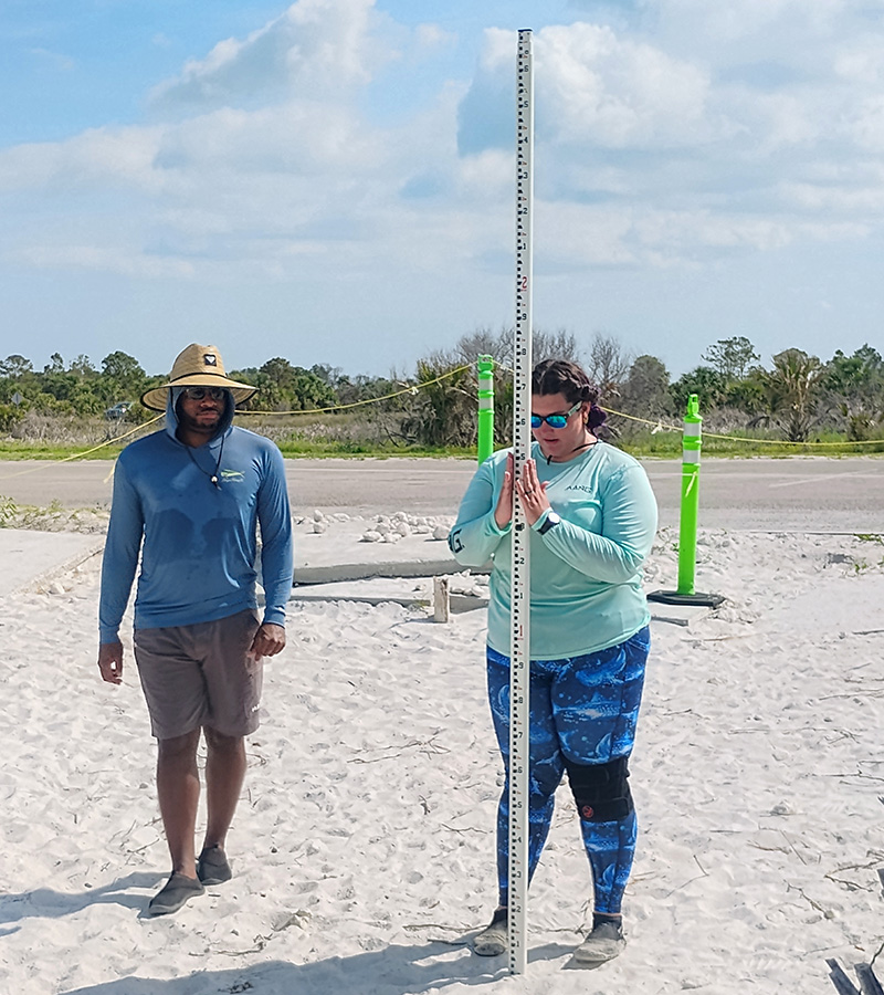 Baranowski was taught tools and techniques, such as how to use this stadia rod to measure the beach elevation at Honeymoon Island, as part of the Oceanography Camp Especially for Girlsfield trips. 