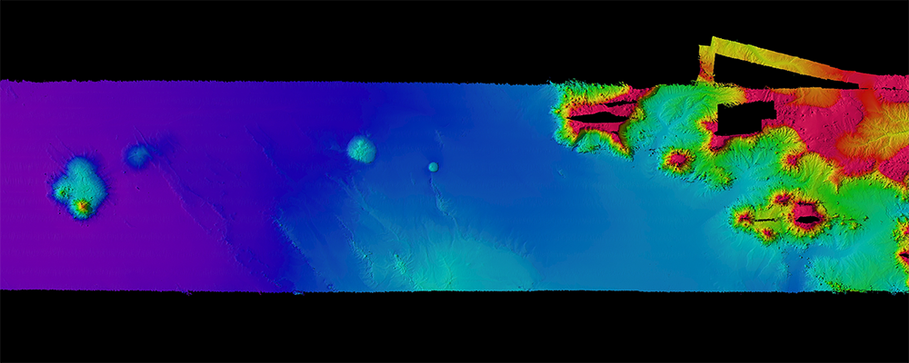Bathymetric data collected at Palmyra and Kingman Atolls south of Hawaii, an example of the type of data Jacob Stock works with. Deeper, flatter seafloor can be seen to the west, and complex seamounts to the east.