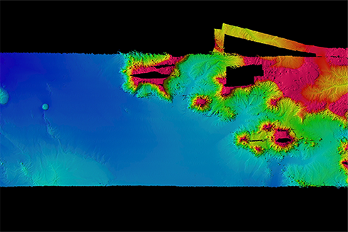 Bathymetric data collected at Palmyra and Kingman Atolls south of Hawaii, an example of the type of data Jacob Stock works with. Deeper, flatter seafloor can be seen to the west, and complex seamounts to the east.