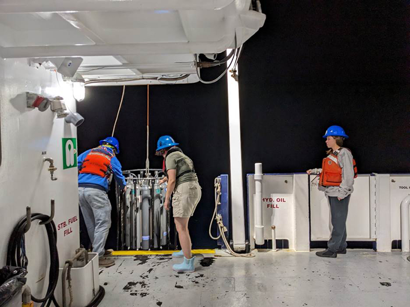 Brooker (far-right) observing FIO’s Science Technician, Marshall Kormanec (left) and Verrill (right) perform a CTD cast and collect water samples. PHOTO CREDIT: Sarah Grasty.