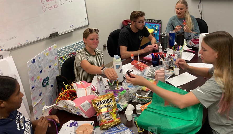 Campers (left to right) Alishya, Faylynn, and Emilie make candy models of DNA to learn the different structures and demonstrate how it is read within the cell, during the DNA detectives lab.