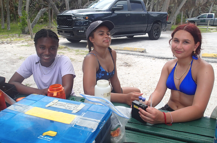 Campers (left to right) Zoe, Sawyer, and Maia waiting for their nutrient tests to finish while at Arrowhead Park at Ft. De Soto.