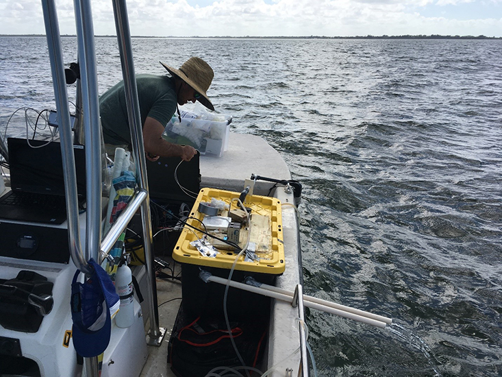 Chris Moore making adjustments to the automated, flow-through pH sampler out at the mouth of Tampa Bay. 