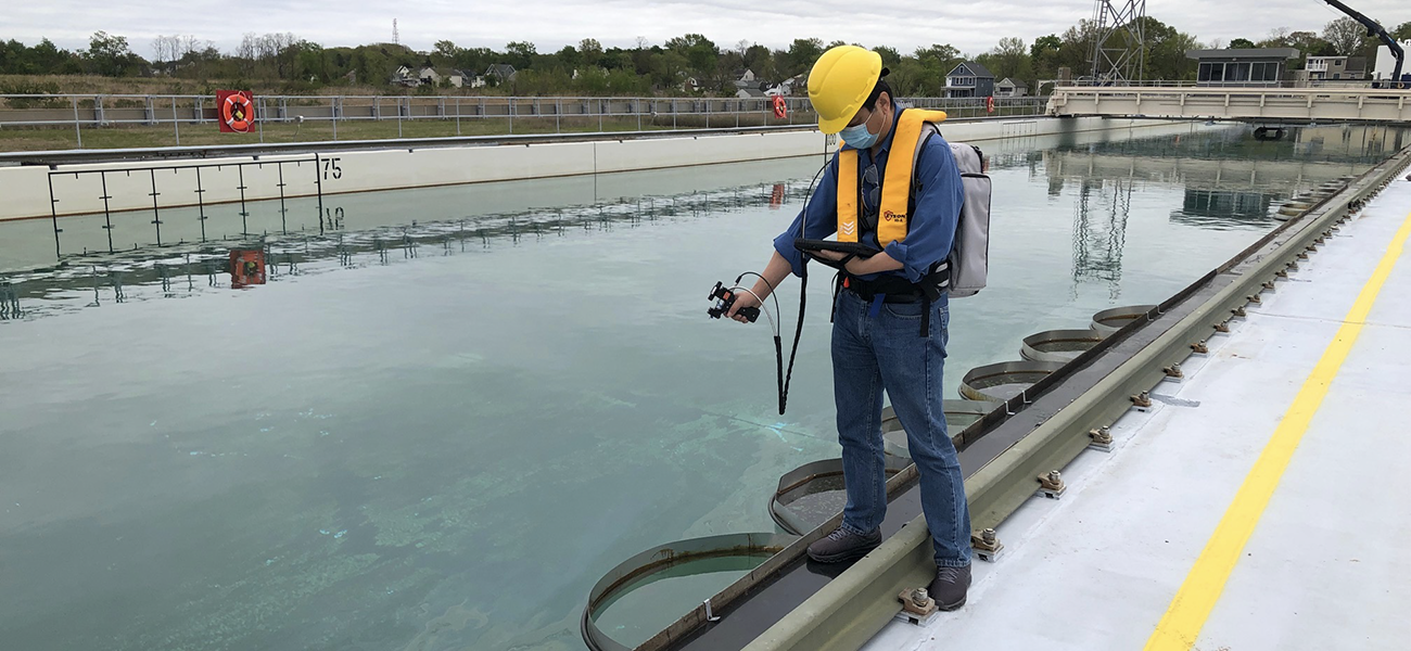 Chuanmin Hu takes optical measurements of oil on water in a field experiment. Image courtesy of Chuanmin Hu.