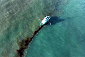 In this photo provided by the U.S. Coast Guard, a Clean Gulf Associates 95-foot response vessel skims crude oil approximately 4 miles southeast off South Pass Louisiana, Friday, Nov. 17, 2023. A Unified Command composed of the Coast Guard, Main Pass Oil Gathering Company, LLC, and the Louisiana Oil Spill Coordinator's Office is coordinating measures to assess, contain and mitigate the impact of the spill. (U.S. Coast Guard/Courtesy Clean Gulf Associates via AP)