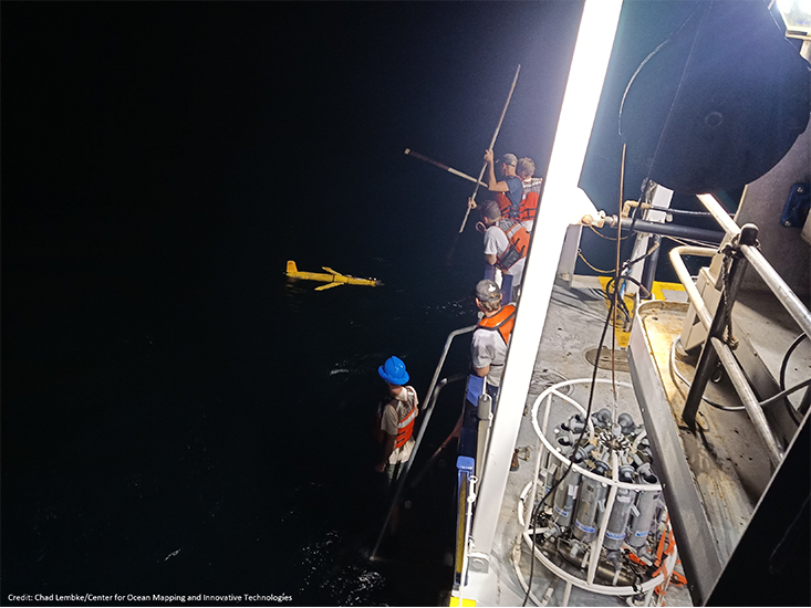 Above: A nighttime glider deployment. PHOTO CREDIT: Chad Lembke, Center for Ocean Mapping and Innovative Technologies.