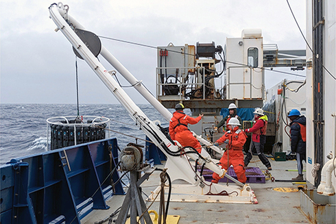 GEOTRACES has been an international effort involving hundreds of scientists and more than 150 research cruises. Here, crew members aboard the R/V Roger Revelle, including CMS graduate student Dylan Halbeisen, recover a GEOTRACES carousel rosette during an arctic cruise. Photo credit: Jennifer Middleton, Lamont-Doherty Earth Observatory.