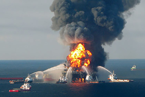 Oil spill responders attempting to extinguish the flames of the Deepwater Horizon platform at the onset of the accident in 2010. (Photo Credit: US Coast Guard)