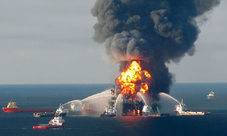 Oil spill responders attempting to extinguish the flames of the Deepwater Horizon platform at the onset of the accident in 2010. (Photo Credit: US Coast Guard) 