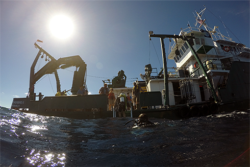 Research divers reboard the Weatherbird after visually examining the new buoy. (Photo credit: Jay Law)