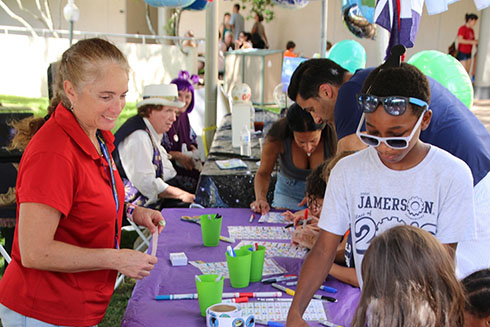 Dr. Christina Simoniello guides young students through an activity at the GCOOS booth during the 2017 St. Pete Science Festival.