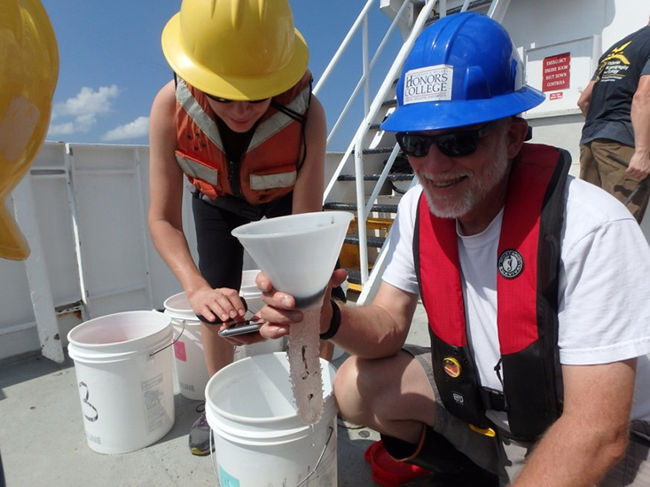 (L-R) Dr. Isabel C. Romero (College of Marine Science University of South Florida) and Dr. Jon Moore (Wilkes Honors College at Florida Atlantic University) collect samples from midwater trawling that used a 10-m2 MOCNESS net during DEEPEND Consortium cruises. Photo Credit: Isabel Romero, courtesy of DEEPEND. 