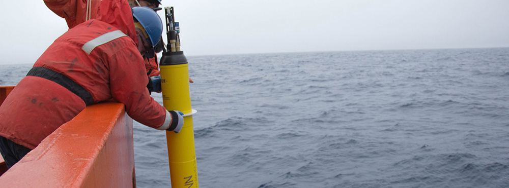 Two scientists deploy a biogeochemical Argo float aboard the R/V Palmer during a research cruise to the Southern Ocean. Photo courtesy of Greta Shum, SOCCOM project.