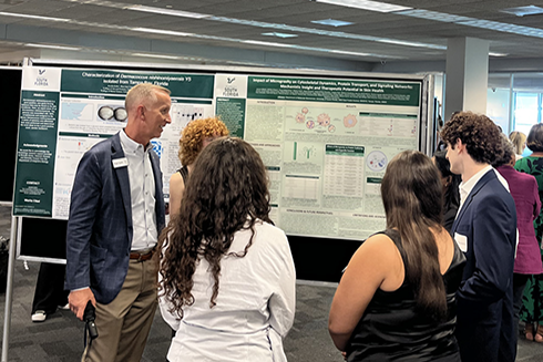 Florida High Tech Corridor CEO Paul Sohl talks to students on the USF St. Petersburg campus during the OneUSF Summer Undergraduate Research Symposium.