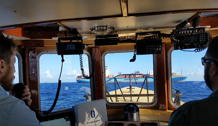 Harbor pilots, specialized in directing vessels in and out of harbors, approach an incoming ship to guide it into port in Miami. 