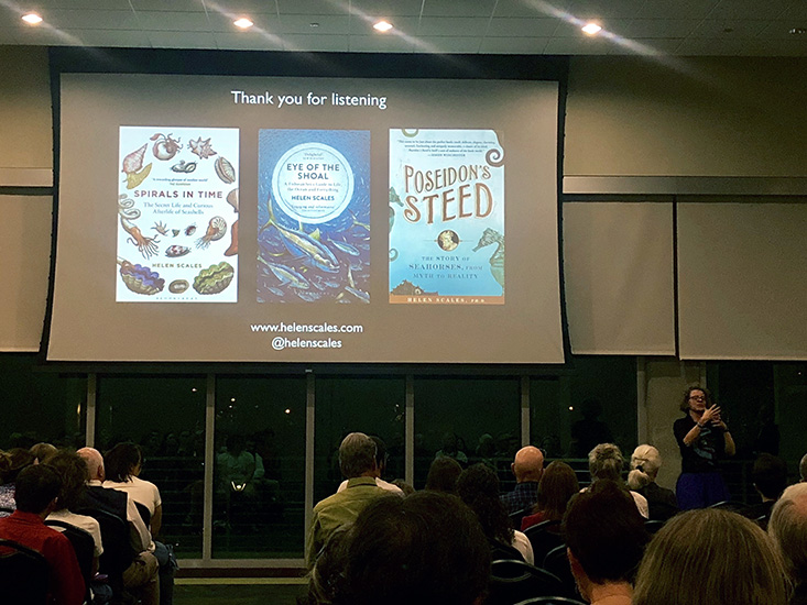 Dr. Helen Scales, bottom right, poses with a slideshow of three of her books.