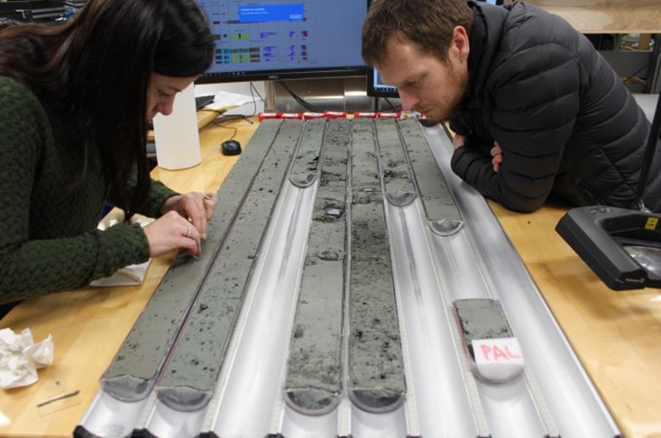 Amelia Shevenell (IODP Expedition 374 lead sedimentologist) and Co-chief Rob McKay (Victoria University, New Zealand) examine sediment cores aboard the JOIDES Resolution in the Ross Sea Antarctica, 2018 (Photo by M. Leckie)