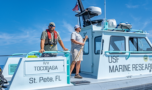 Jay Law and Ben Meister look out from the Tocobaga's starboard.