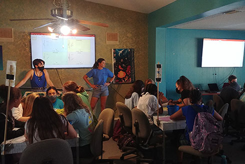 Science Mentors Bella and Kylee present the fisheries data to the campers.