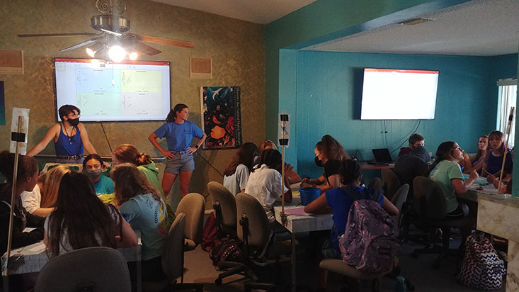 Science Mentors Bella and Kylee present the fisheries data to the campers.