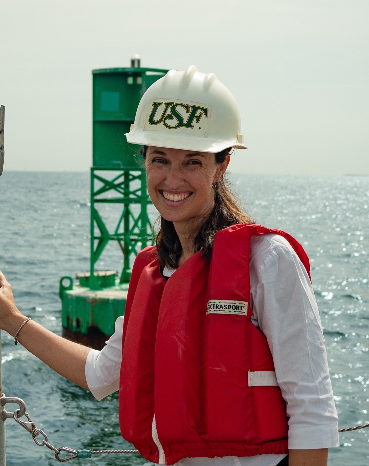 Laura Azevedo, PhD student at the College of Marine Science, visiting a buoy she used in her study of rogue waves in Tampa Bay. 
