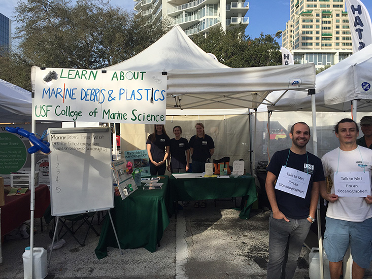 USF CMS graduate students, Luis Sorinas, Juan Millan, Becky Scott, Shannon Burns, and Maddie Schwaab, at the CMS outreach booth, excited to teach the public about marine debris. 