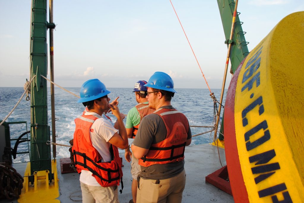 Luis Sorinas Morales (left) discusses operations with Sebastian DiGeronimo (right) before deploying a buoy.