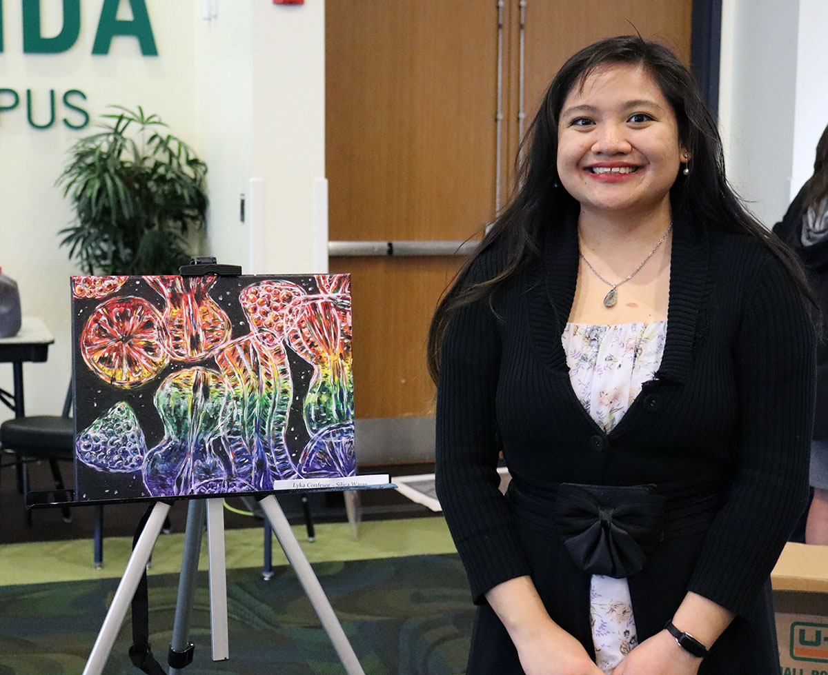 CMS grad student Lyka Confesor showcasing her artwork titled “Silica Waves.” Photo Credit: Makenzie Kerr.