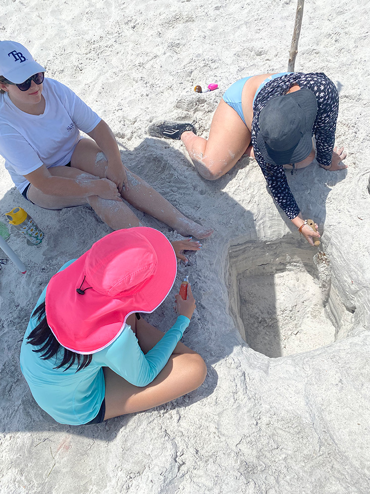 Campers examine different sediment layers within the pit.