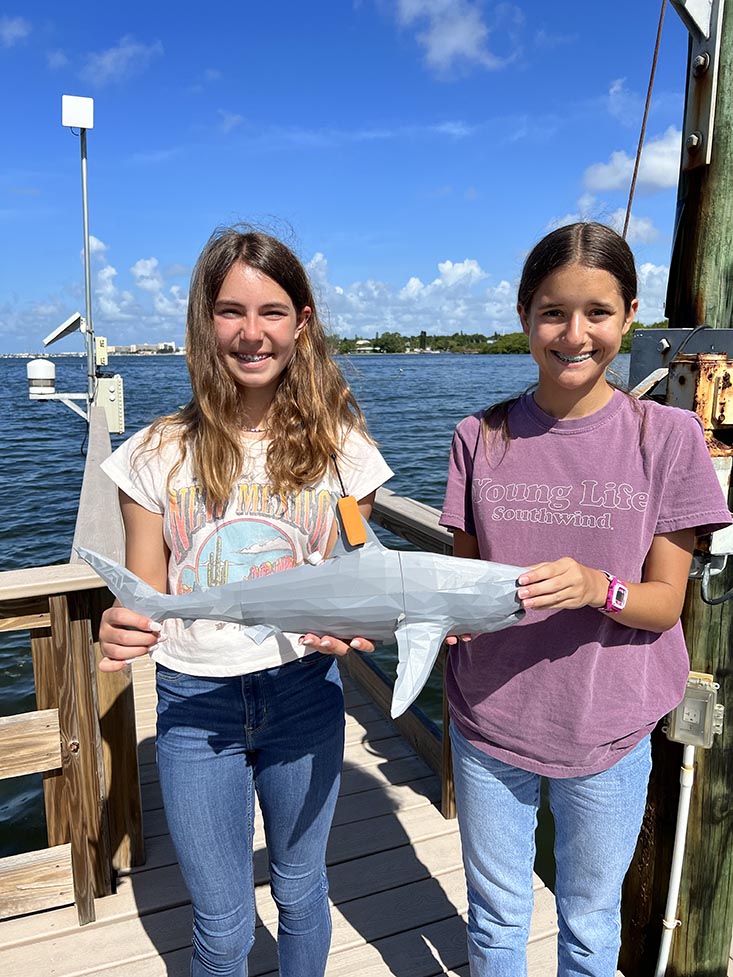 Campers Ella and Maddison holding the 3D printed shark model.