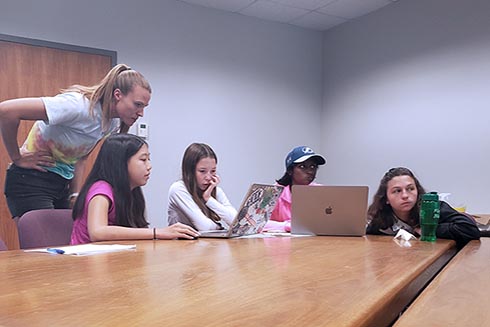 Science Mentor Becky assists campers Emily, Katie, Smithi, and Carissa with creating their MPA using ArcGIS.