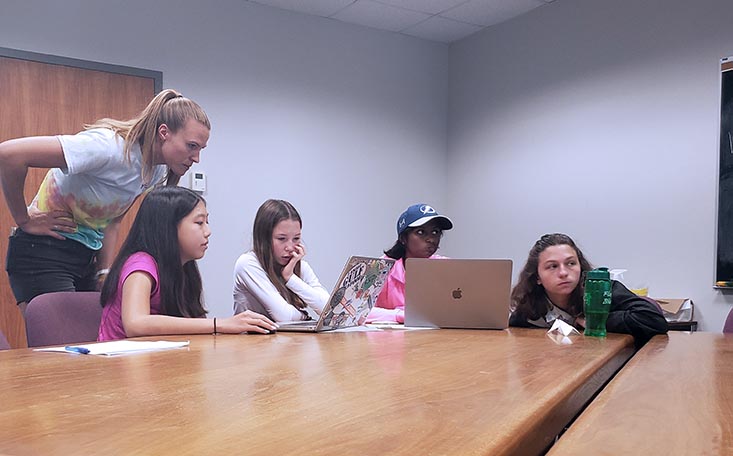 Science Mentor Becky assists campers Emily, Katie, Smithi, and Carissa with creating their MPA using ArcGIS.