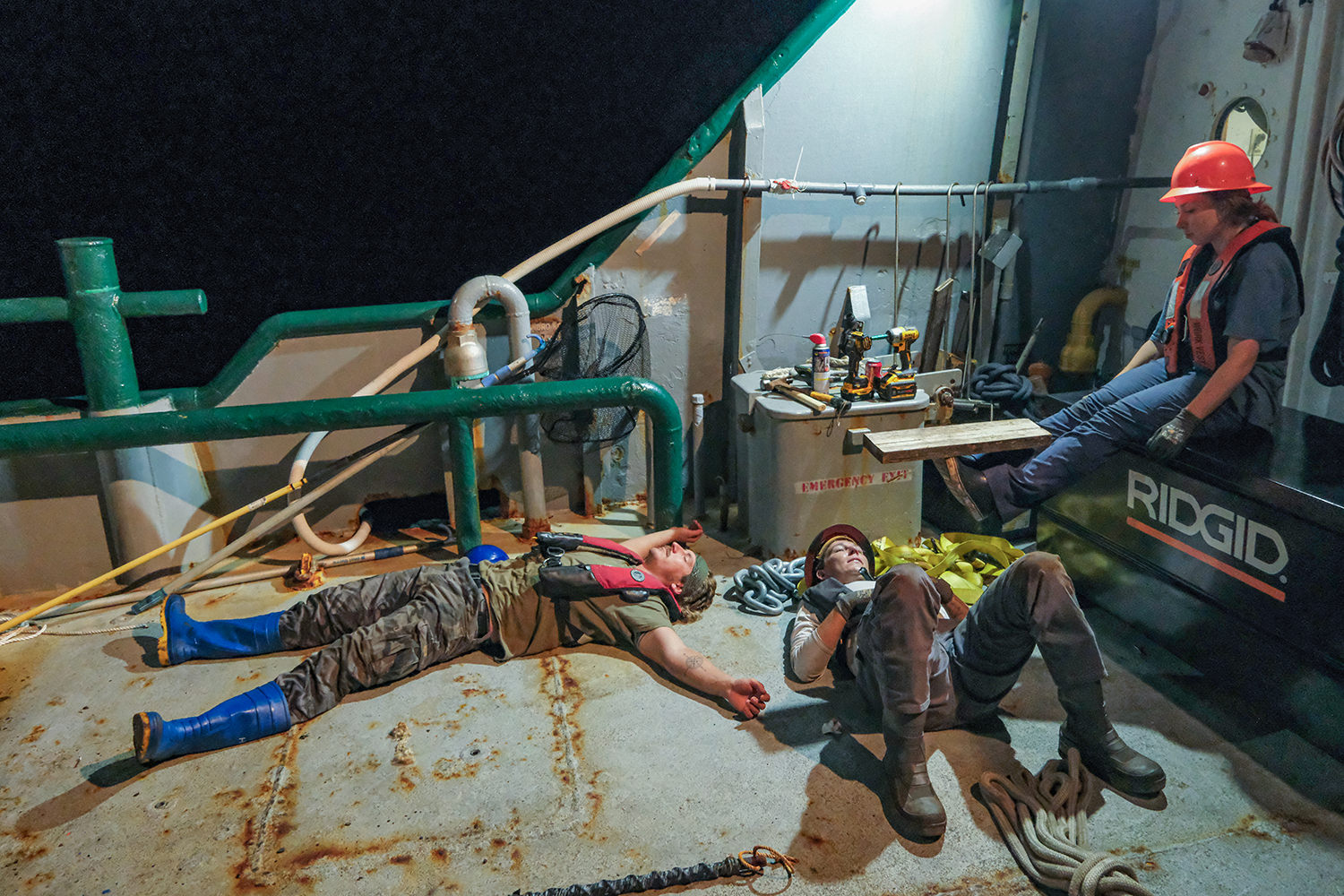 Orion Scharton-Witmer, Sam D’Angelo, and Lillian Ring rest after a night-time buoy deployment. Credit: Jackson Sullivan