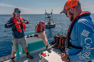 Orion Scharton-Witmer, Sam D’Angelo, and Mitch Lemon service buoys in the Gulf. Credit: Jackson Sullivan