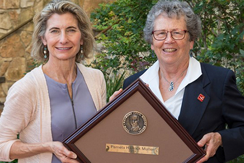 Dr. Pamela Hallock Muller receiving the Raymond C. Moore Medal from Dr. Lynn Soreghan, President of SEPM and James Roy Maxey Professor of Geology at the University of Oklahoma. 