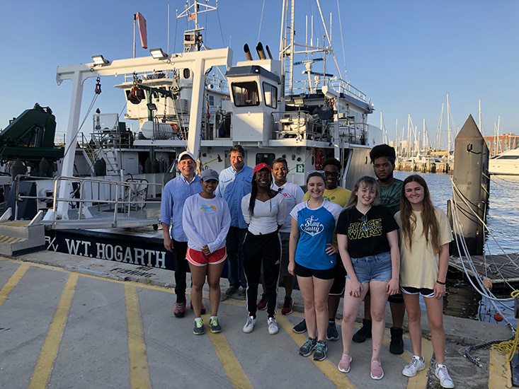 BACK ROW: REU student Richard Rivera, David Naar (USF College of Marine Science), Ojas Natarajan (Postdoctoral fellow, Dr. Larry Dishaw's lab), REU student Tione Grant, REU student Angel Cedeño; FRONT ROW: Celine Atkinson (Graduate student in Dr. Larry Dishaw's lab), REU student Jenelle DeVry, Shelby Mahank (Graduate student, USF St. Petersburg, who also works with Mya Breitbart in the USF College of Marine Science), Paige Boleman (USF St. Petersburg undergraduate student who worked in Mya Breitbart's lab), Hannah Leary (undergraduate student from the University of Texas at Austin who interned in the lab of Mark Luther at the USF College of Marine Science). Not shown: REU student Alexis Peterson.