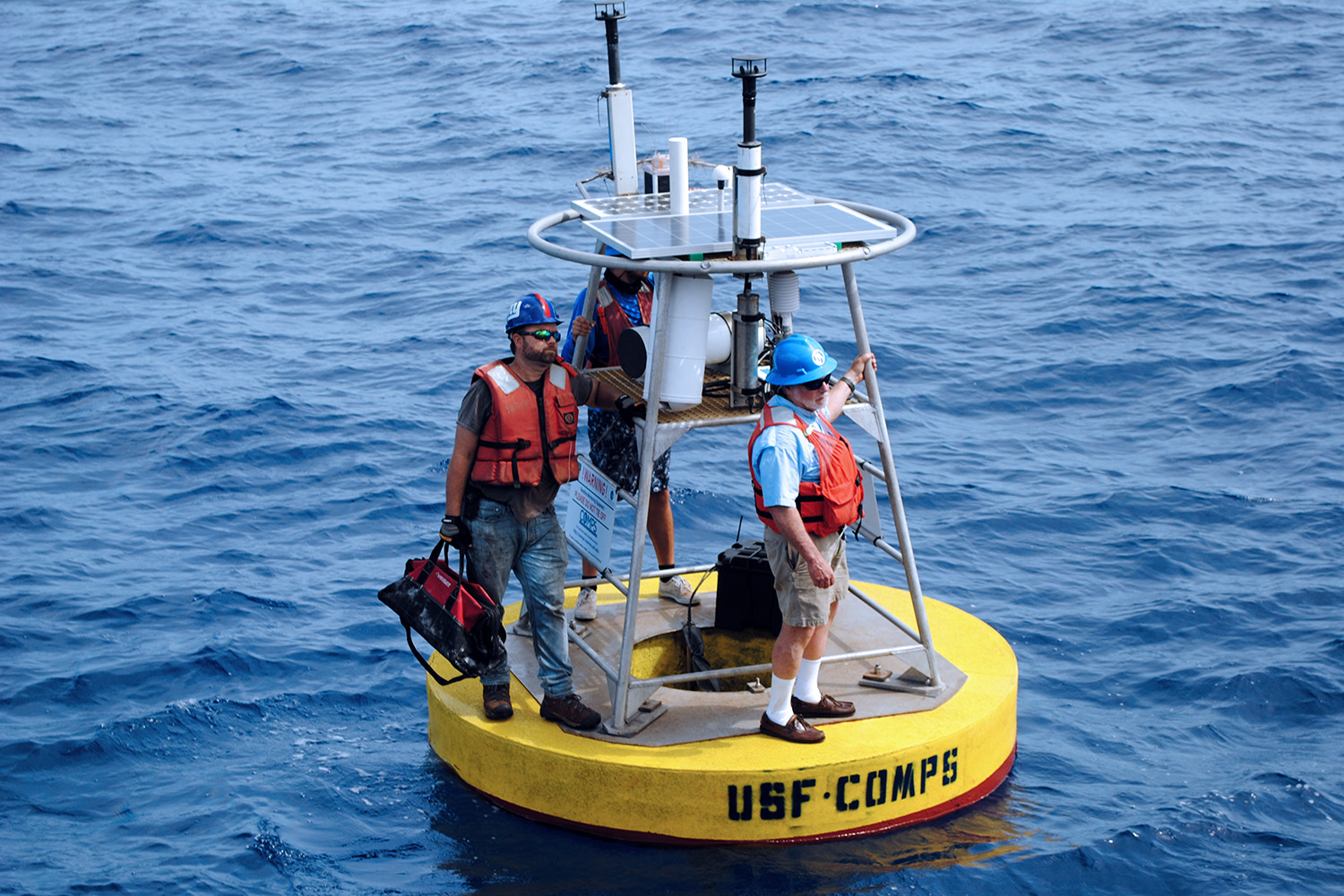  Robert Weisberg (right), USF Distinguished University Professor, stands on a buoy with Jay Law (left), research scientist in the Ocean Circulation Lab